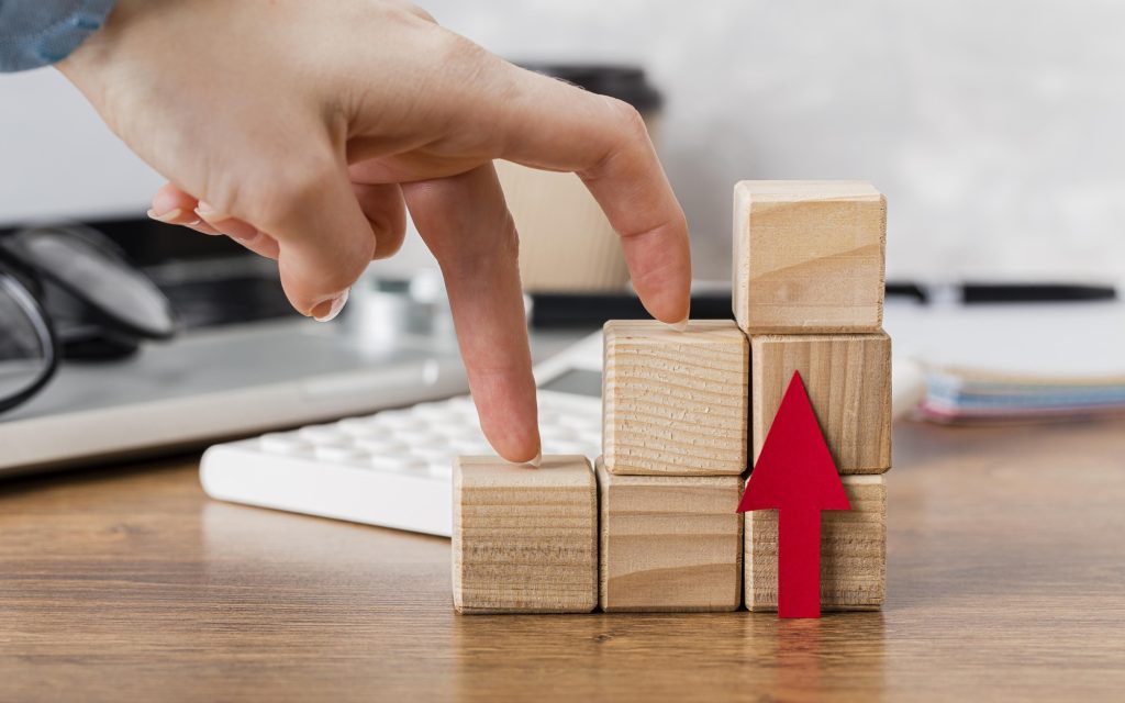 hand-climbing-wooden-blocks-represent-growth